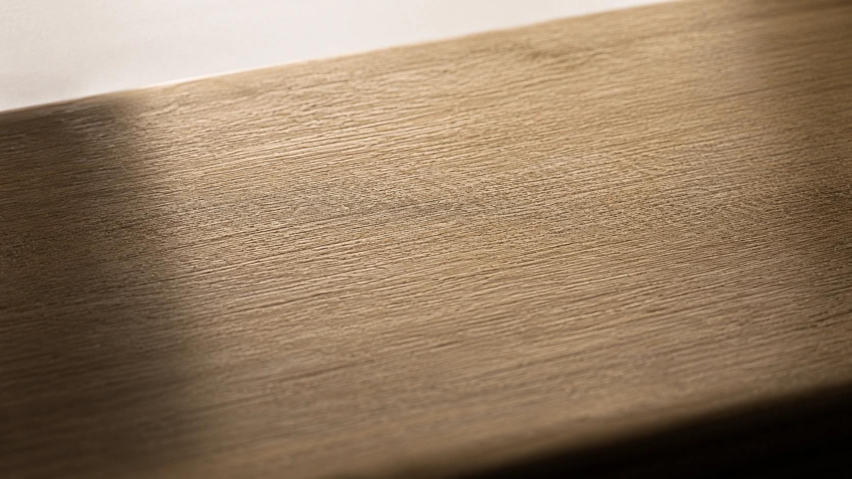 A macro of a brushed brass surface with a soft, warm patina.